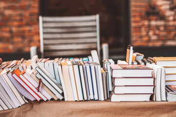 Pile of books on table outdoor. Abstract blurred background . Education, school, study, reading...