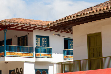 Streets of a town in Colombia, where you can see people walking through colored houses. Town in the mountains of Latin America.