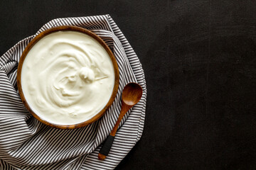 Dairy product - sour cream or yogurt in wooden bowl