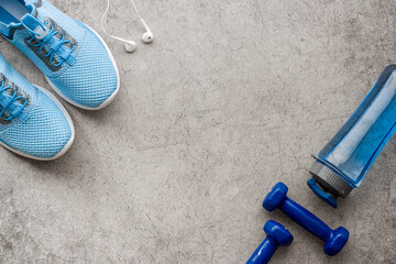 Fototapeta na wymiar Sport fitness flatlay with sneakers and dumbbells, top view