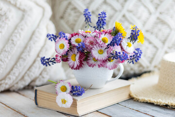 Beautiful spring or summer floral composition with daisy camomile flowers in a white cup for countryside table decor. Greeting card for Women's or Mother's Day, 8th of March. Wooden background