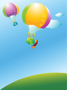 Two colorful balloon flying over a green hill