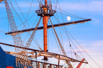 View of a sailing ship in the style of a vintage sailboat against the background of the evening sky...