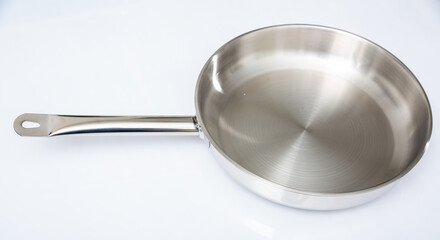 New steel frying pan on wooden background closeup