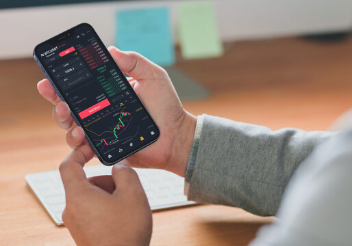 Close-up of a cellphone screen with diagrams. Crypto trader investor broker using smartphone for cryptocurrency financial market analysis, buying or selling cryptocurrency, shares of stock market.