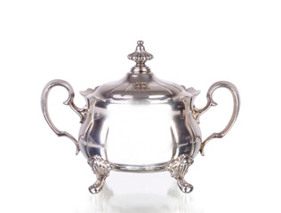 silver sugar bowl on white background with reflection