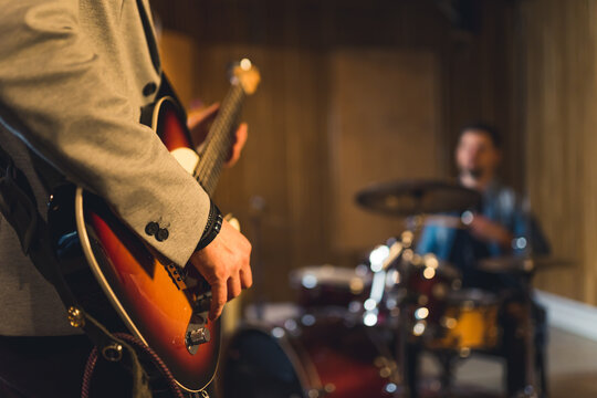 Young indie rock band playing the rehearsal before the concert . High quality photo