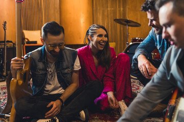 Young indie rock band playing the rehearsal before the concert . High quality photo