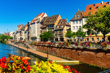 Picturesque view of old French town of Strasbourg with canals and ancient fachwerk houses at sunny summer day