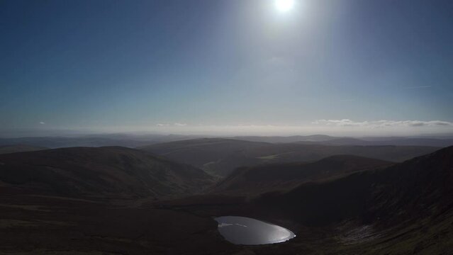 Berwyn Mountain Range Background With Sunshine Over A Lake