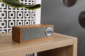Portable speaker on wooden table in teenager's room
