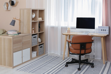 Modern teenager's room interior with stylish workplace