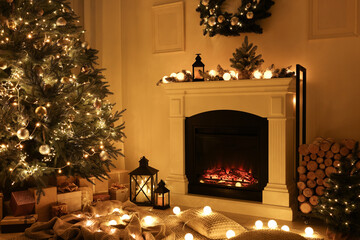 Beautiful living room interior with burning fireplace and Christmas tree in evening
