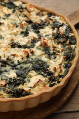 Delicious homemade spinach quiche on table, closeup