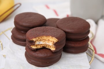 Tasty banana choco pies on stand, closeup