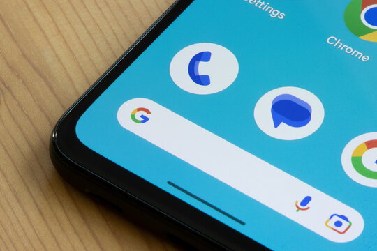 Portland, OR, USA - May 18, 2023: Phone by Google and Messages by Google app icons, and Google search bar, are seen on the home screen of a Google Pixel 4a smartphone.
