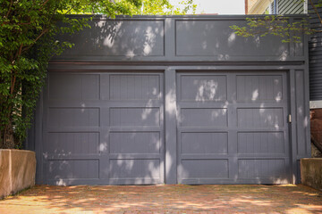 American home garage and driveway symbolize convenience, transportation, and personal space. They represent the ownership of vehicles, storage, and the entrance to one's private domain