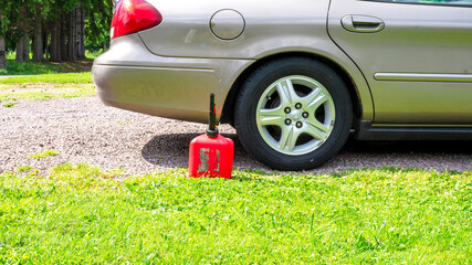 A Rear Quarter View of a Car and a Small Gas Can