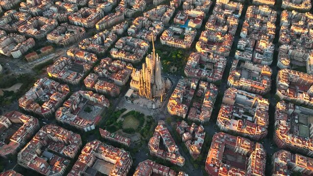 Aerial view of Barcelona Eixample residential district and famous Basilica Sagrada Familia at sunrise. Catalonia, Spain