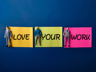 Sticky note and miniature people with word LOVE YOUR WORK