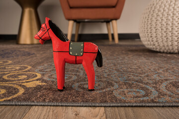 red wooden horse on carpet detail