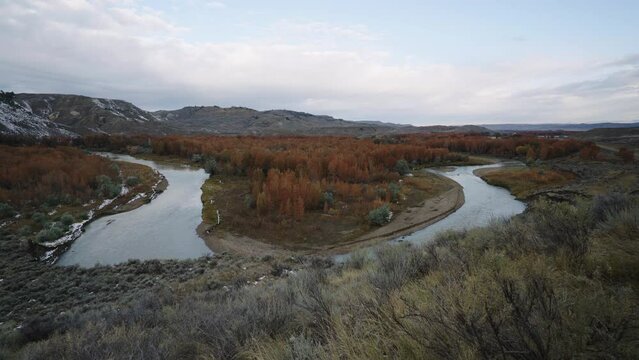 Cloudy morning bend in judith river with autumn trees