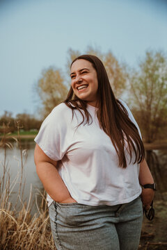 portrait of a plus size woman smiling and looking away