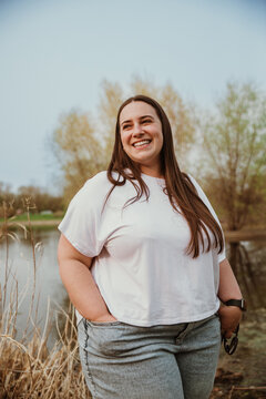 portrait of a plus size woman smiling outside