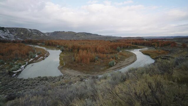 Bend in Judith river with orange foliage and sage brush hills