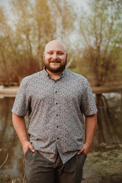 closeup of plus size bald man looking at camera