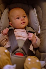 Portrait of little baby girl in baby stroller