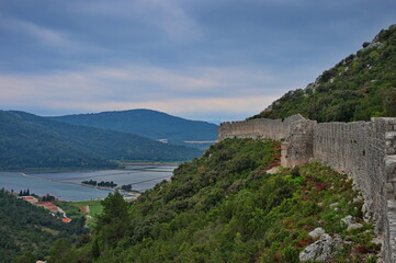 Fototapeta na wymiar Medieval city walls in Ston, Croatia with salt pans in background