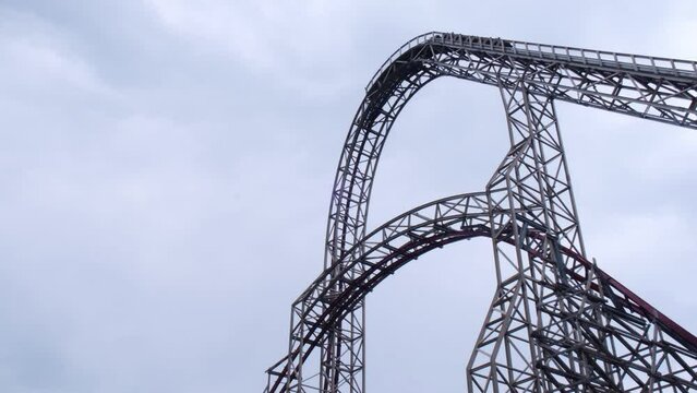 Riding the roller coaster at Energylandia Zator Poland amusement park. Solar powered roller coaster. Rollercoaster against blue sky sunset Wooden outdoor leisure family time 
