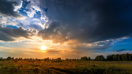 Evening sky and rain clouds, countryside landscape. Summer season.