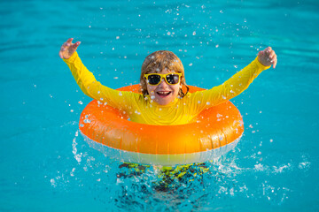 Summertime vacation. Kid with inflatable ring in swimming pool. Summer vacation. Summer holiday....