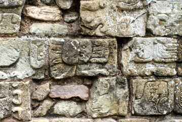 Carved stones in a wall at the Mayan ruins in Copan, Honduras