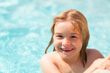 Kid splashing water in pool. Little kid splashing in blue water of swimming pool. Cute child swimming and splashing water with drops in pool. Child splashing and having fun in swim poolside.