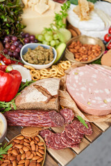 Salami sausage close-up. Table full of mediterranean appetizers, tapas or antipasto. Assorted Italian food set. Delicious snack on party or picnic time. Meat and cheese. Italian style banquet. 