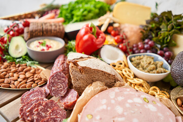 Salami sausage close-up. Table full of mediterranean appetizers, tapas or antipasto. Assorted Italian food set. Delicious snack on party or picnic time. Meat and cheese. Italian style banquet. 