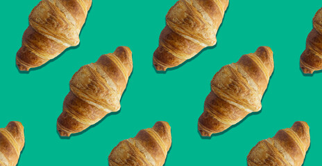 Freshly baked croissant on colored background