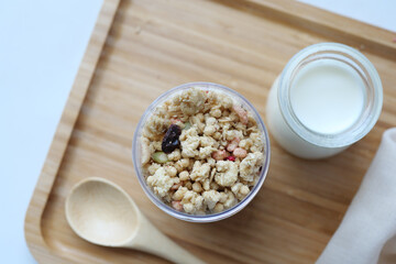 granola Musli and glass of milk on table 
