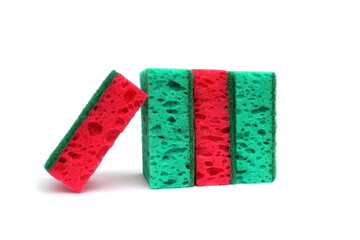 On a white background are many soft sponges for dishes in green and red.