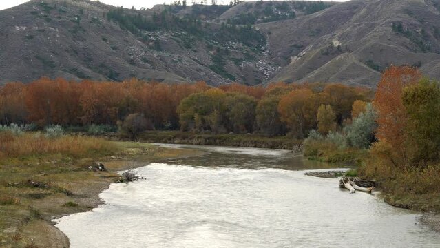 Looking upstream along Judith river at orange fall foliage