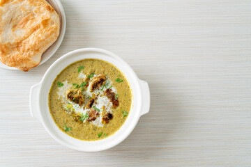 Afghani chicken in green masala curry or Hariyali tikka chicken hara masala with roti or naan bread