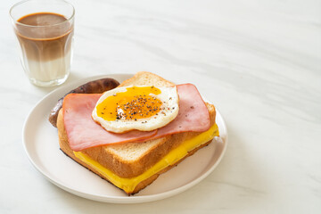 bread toasted cheese topped ham and fried egg with pork sausage