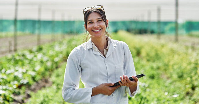 Portrait, tablet and agriculture with a woman in a greenhouse on a farm for organic sustainability. Food, spring and a female farmer outdoor to manage fresh vegetables or produce crops for harvest