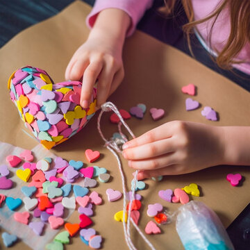 Step 4. Child stuffs the paper heart with colorful sweets. Handmade gift with sweets for wedding, Valentine's or Mother's day. Recycled craft for kids ... See More
