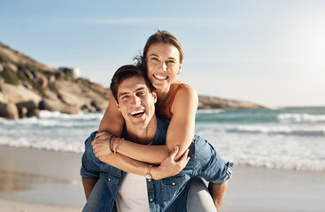 Young couple, portrait and piggyback at beach in summer sunshine with love, romance and bonding with travel. Man, woman and happy with hug, ocean waves and smile in nature, outdoor and vacation