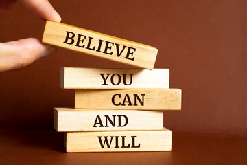 Wooden blocks with words 'Believe you can and will'. Motivation Quote