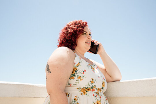 plus size woman talks on phone